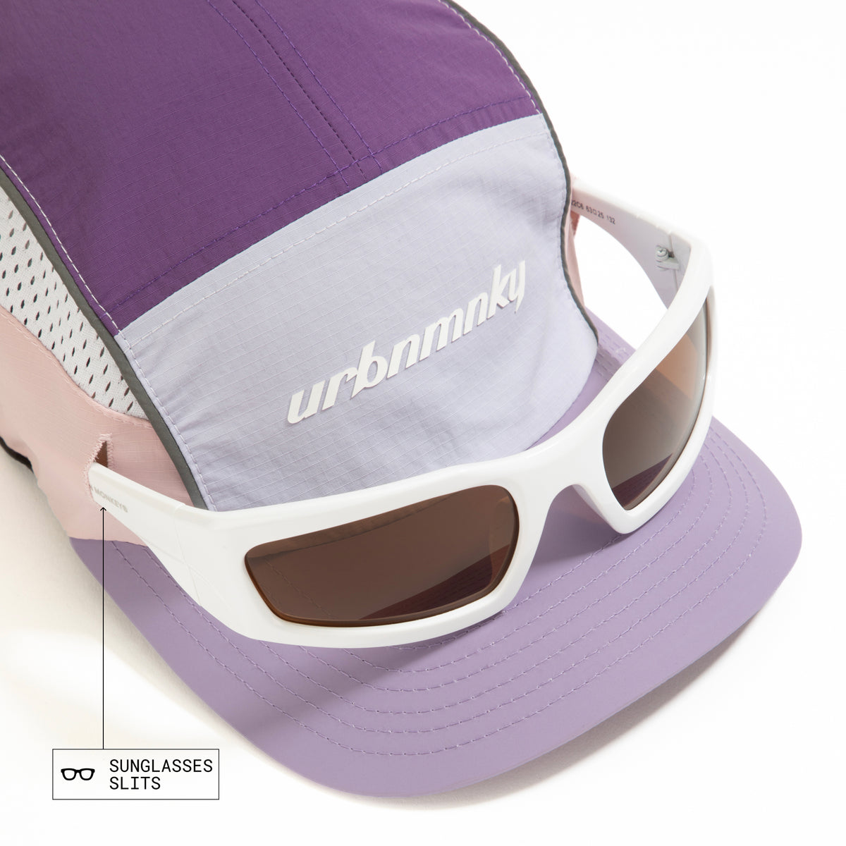Top view of lilac, purple and pink color-block nylon cap with white logo, grey piping and sunglasses slits. Urban Monkey®