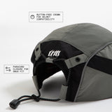 Back view of olive-grey and black color-block nylon cap with white stacked logo and paracord closure. Urban Monkey®