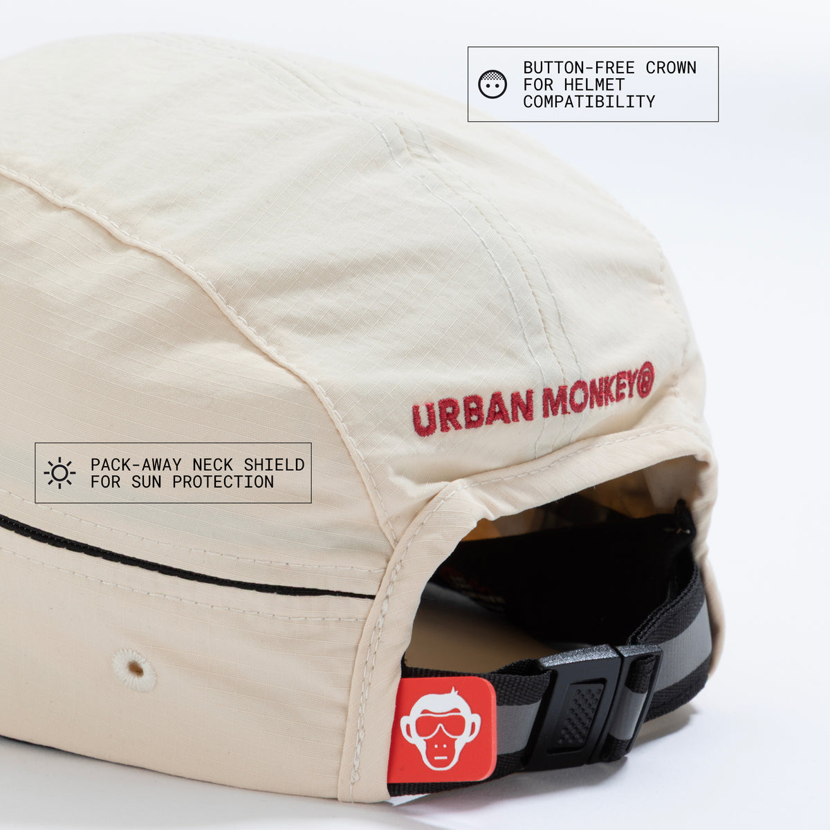 Back view of cream nylon sun cap with rust-red embroidered logo, zip pocket, and adjustable strap. Urban Monkey®