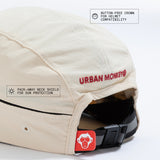 Back view of cream nylon sun cap with rust-red embroidered logo, zip pocket, and adjustable strap. Urban Monkey®