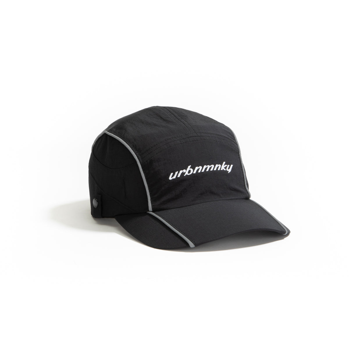 Side view of  black ripstop nylon cap with grey piping and white embroidered logo Urban Monkey®