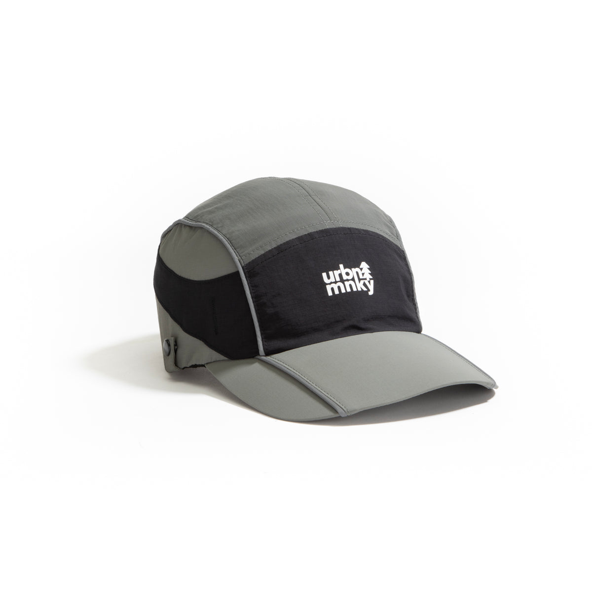 Side view of olive-grey and black color-block nylon cap with white stacked logo and pine tree icon. Urban Monkey®
