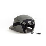 Back view of olive-grey and black color-block nylon cap with white stacked logo and adjustable strap. Urban Monkey®