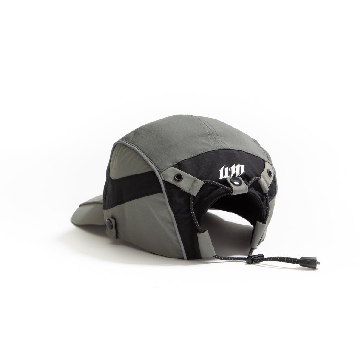 Back view of olive-grey and black color-block nylon cap with white stacked logo and adjustable strap. Urban Monkey®