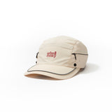 Front side view of cream nylon sun cap with rust-red embroidered logo, zip pocket, and snap button. Urban Monkey®