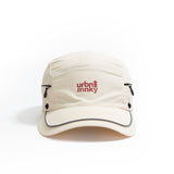 Front view of cream nylon sun cap with rust-red embroidered logo, zip pocket, and snap button. Urban Monkey®