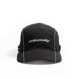 Front view of  black ripstop nylon cap with grey piping and white embroidered logo Urban Monkey®