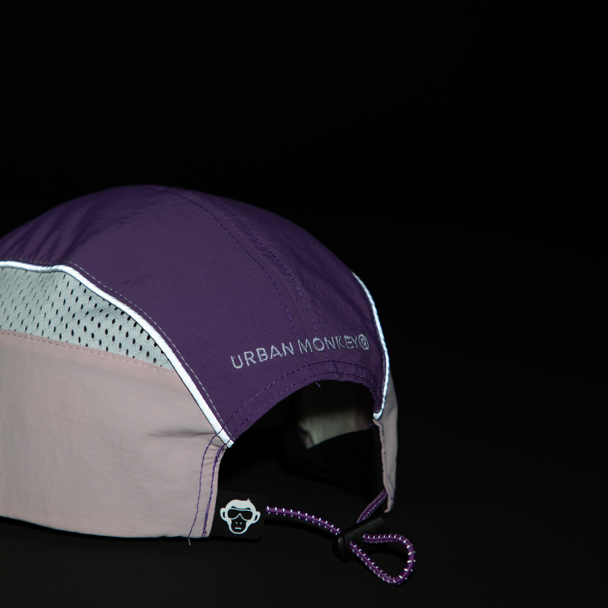 Back view of lilac, purple and pink color-block nylon cap with white logo, radium grey piping and adjustable strap. Urban Monkey®