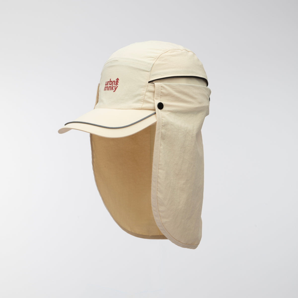 Front side view of cream nylon sun cap with neck flap, rust-red tree logo, zip pocket and piped brim,. Urban Monkey®