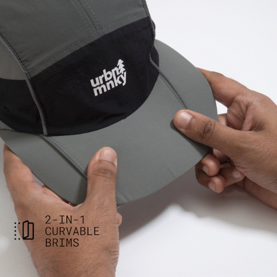 Top view of olive-grey and black color-block nylon cap with white stacked logo and pine tree icon and flexible panel. Urban Monkey®