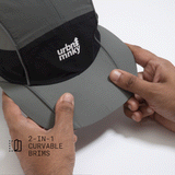 Top view of olive-grey and black color-block nylon cap with white stacked logo and pine tree icon and flexible panel. Urban Monkey®