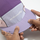 Front top view of lilac, purple and pink color-block nylon cap with white logo, grey piping and felixable panel. Urban Monkey®