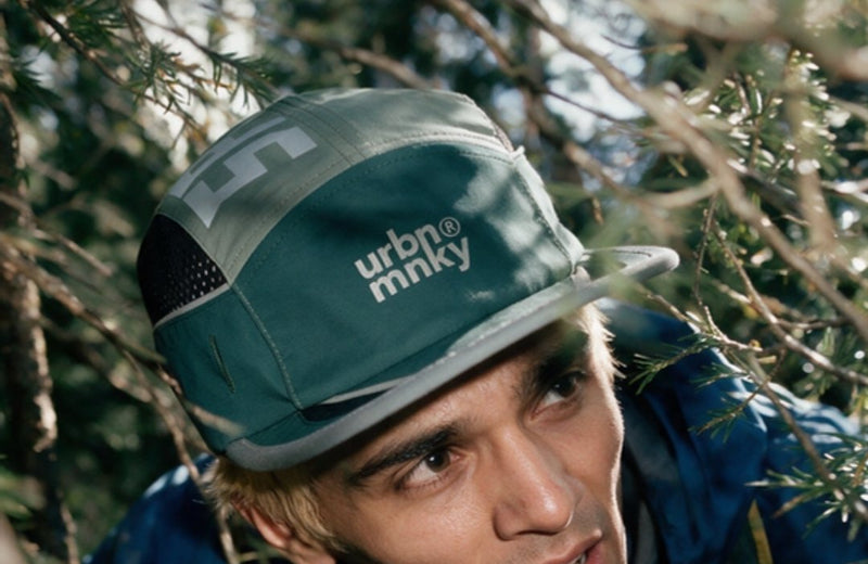 Runner in the Trail cap on a forest trail