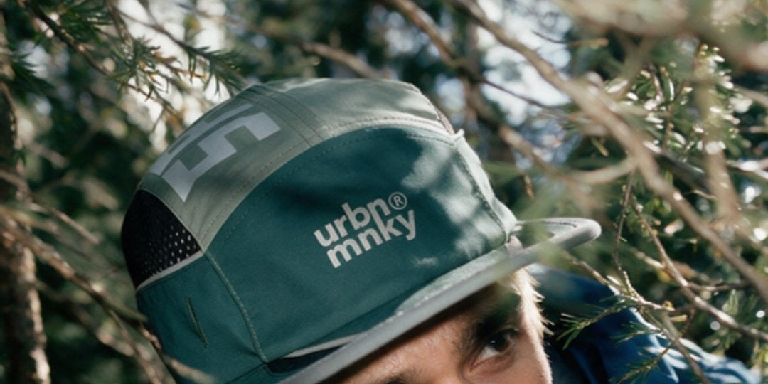 Runner in the Trail cap on a forest trail