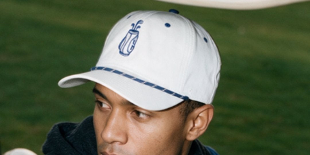 Man wearing the white 19th Hole cap